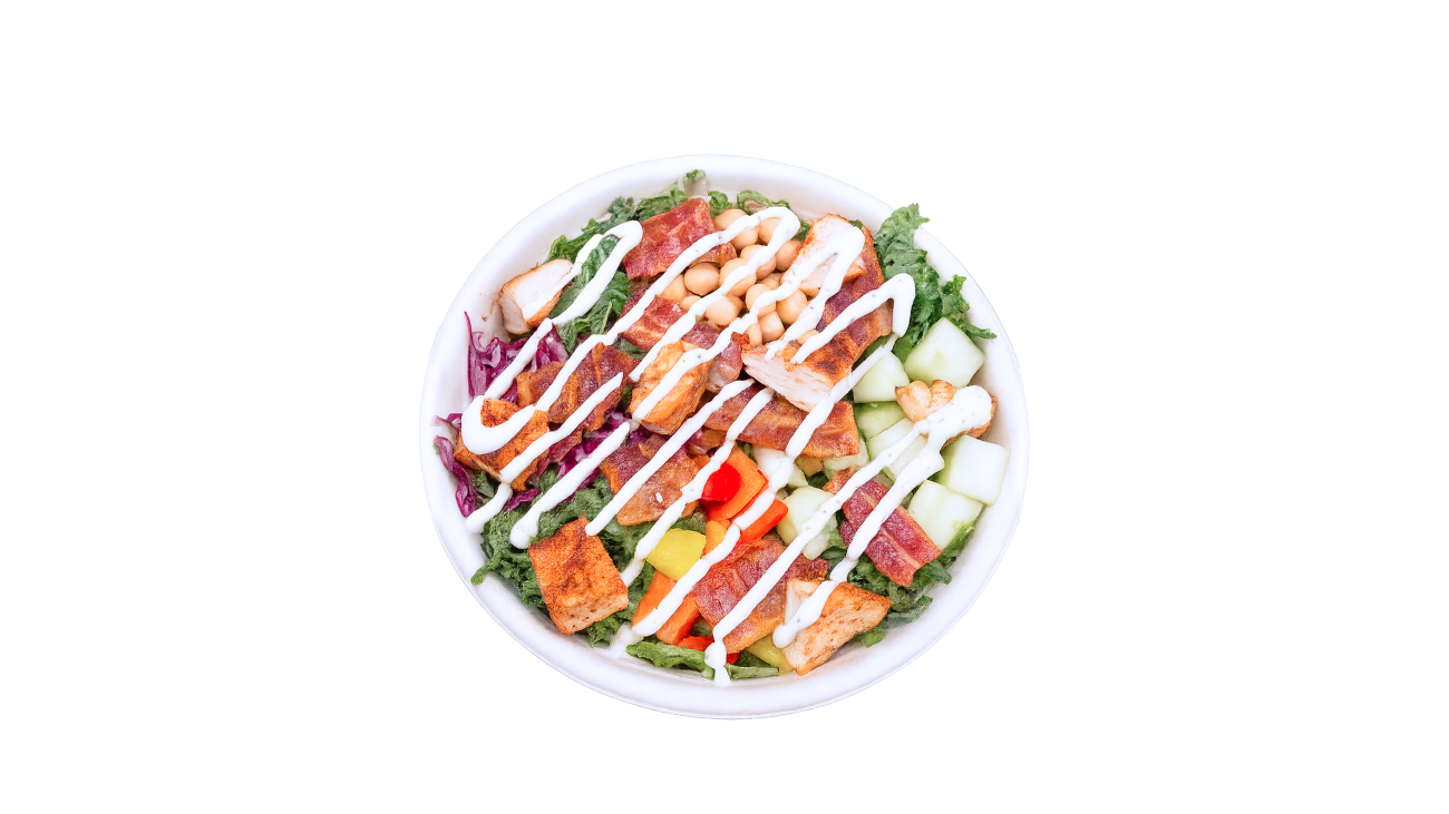 A photo of a finished bowl with chicken, dressing and toppings.